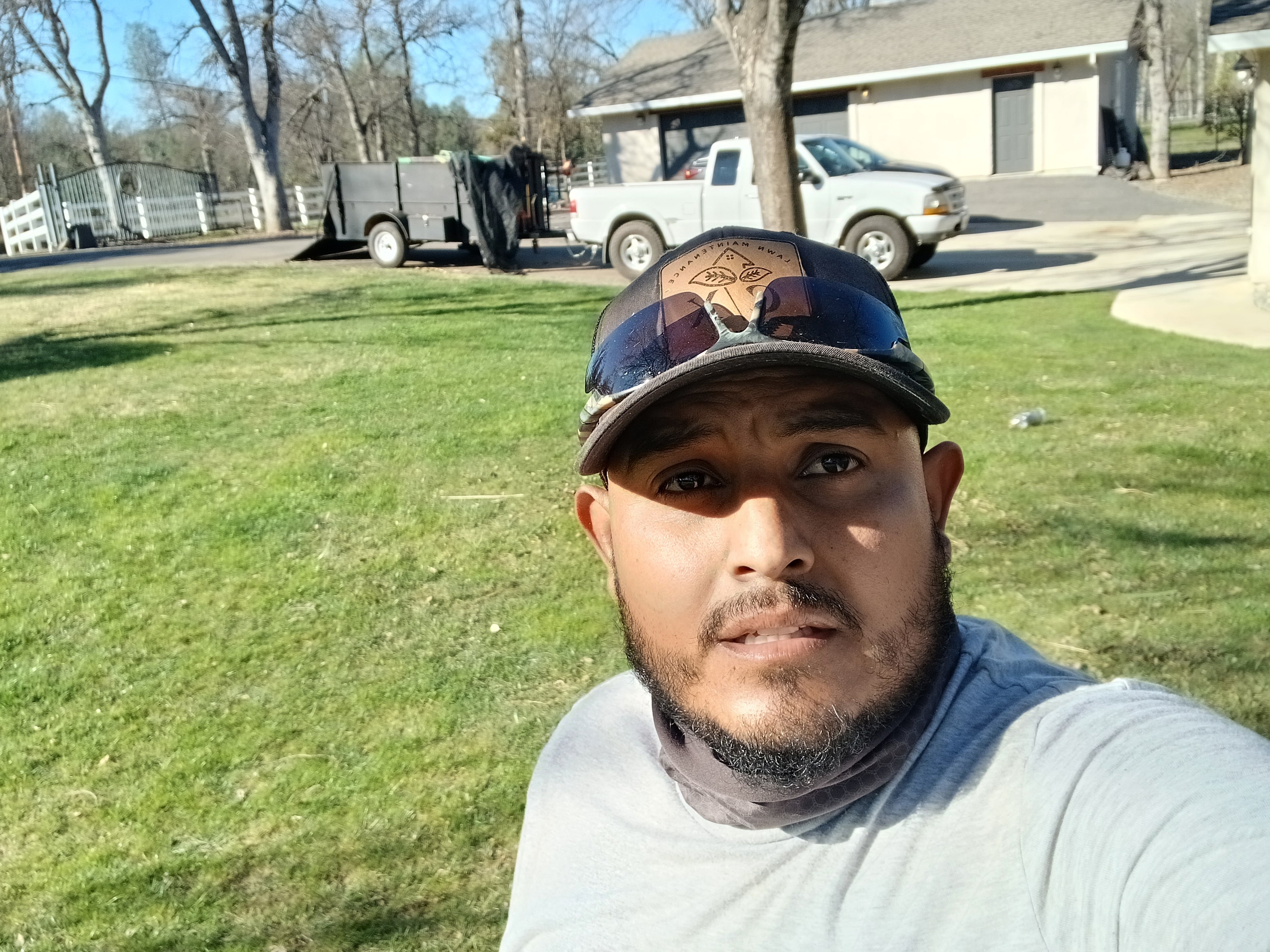 CX Lawn crew member on job site with truck and trailer